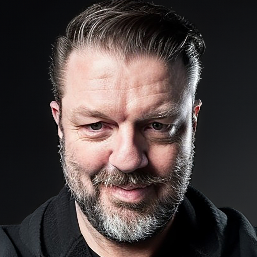Portrait of Mark Royse in black hoodie against a dark background